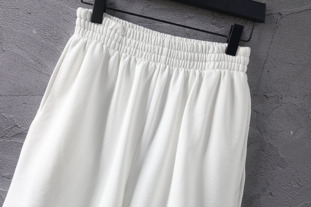 White shorts with elastic waistband and gathered pleats at top