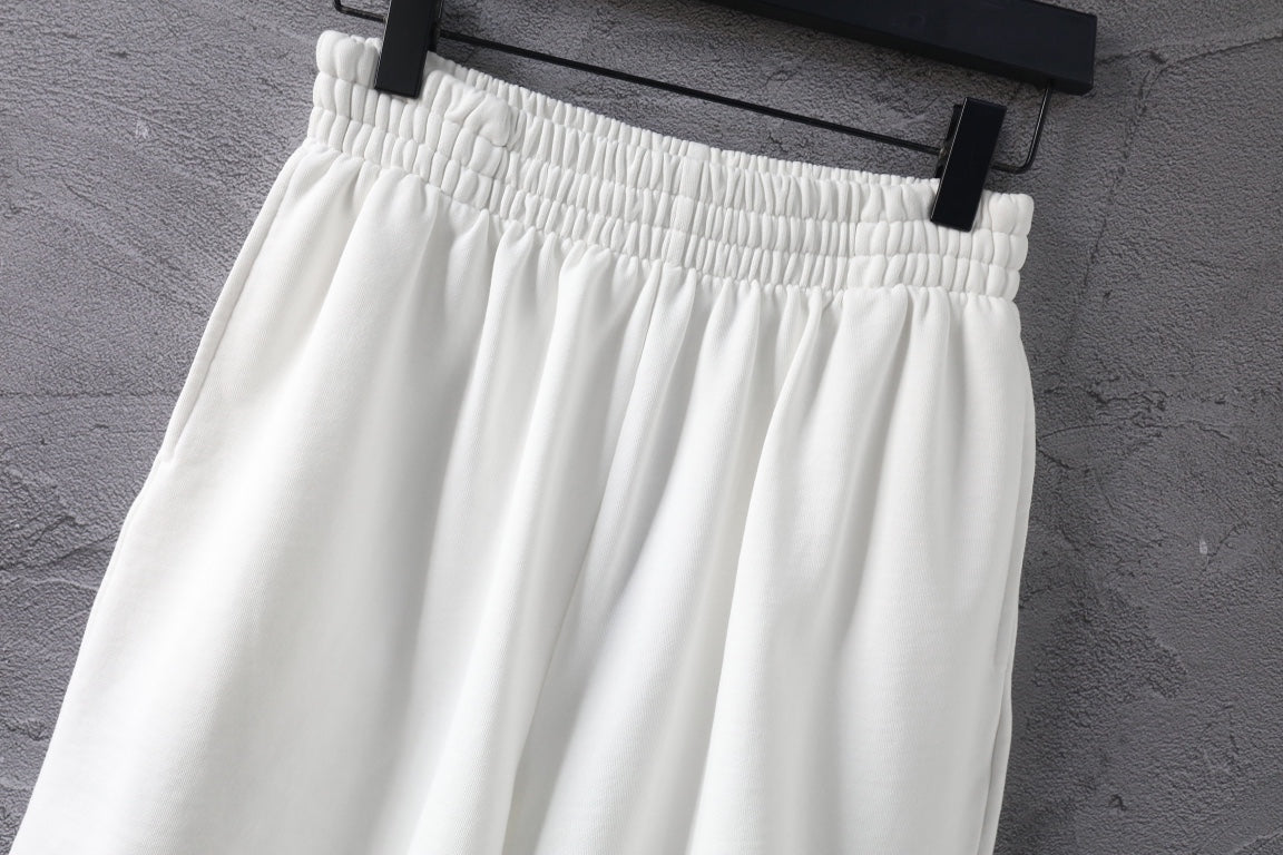 White shorts with ribbed elastic waistband and gathered front.