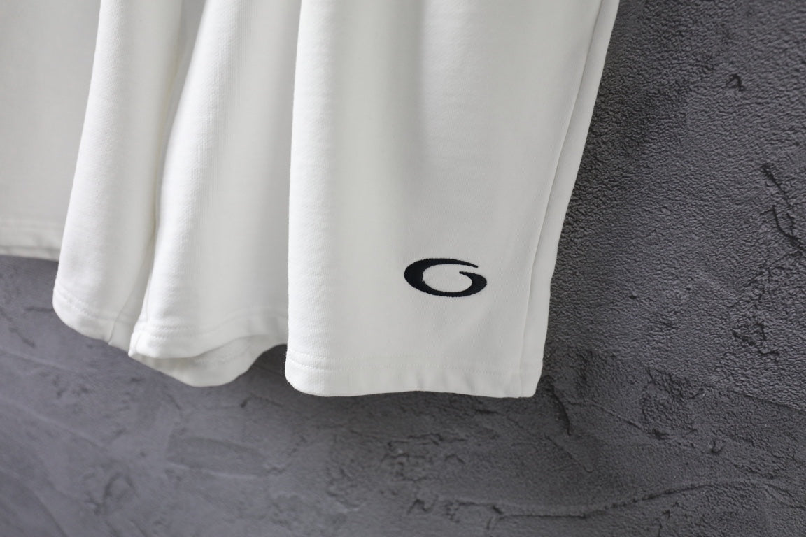 White shorts with black logo on right leg and wide hem