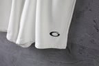 White shorts with a black oval logo near the hem.