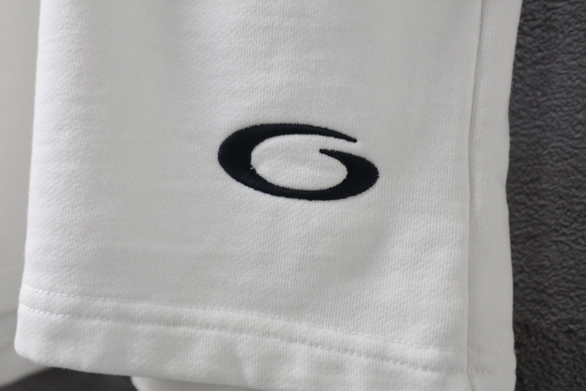 White shorts leg with black oval logo embroidery.