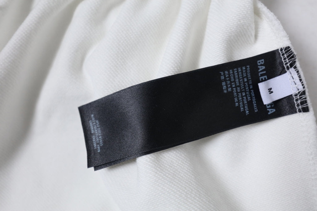 White shorts with black inner size label and brand text on waistband