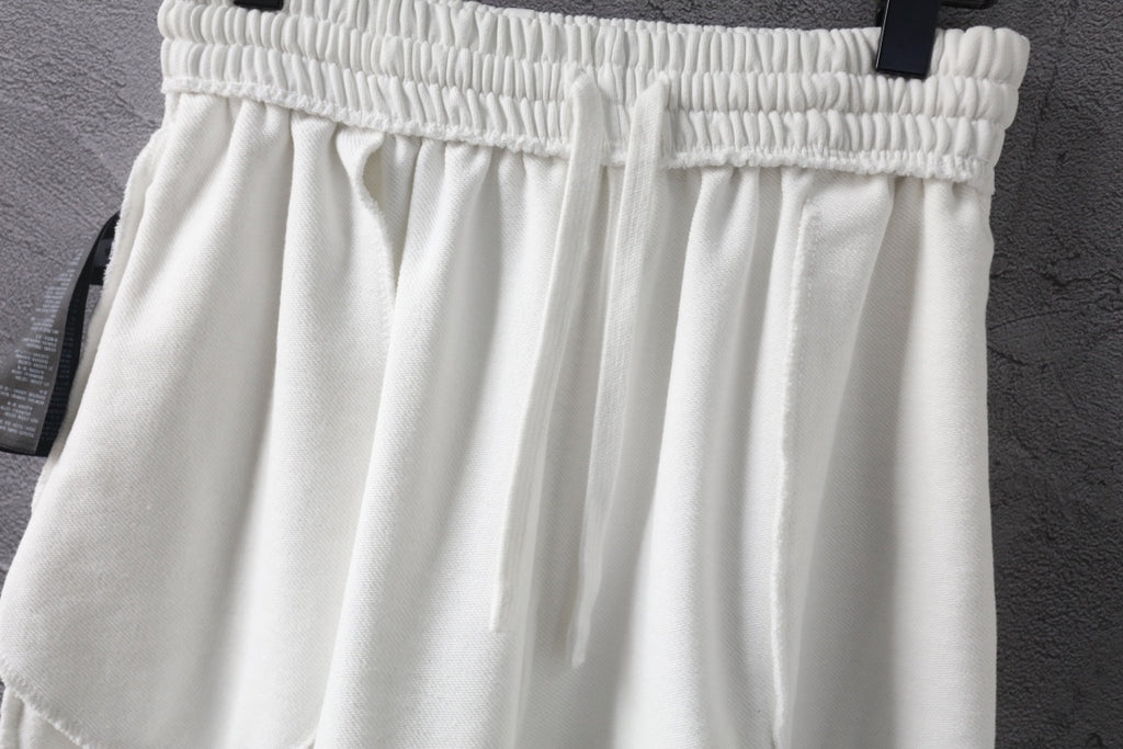 White shorts with elastic waistband and overlapping front pleats