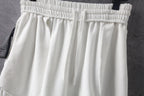White shorts with elastic waistband and overlapping front pleats