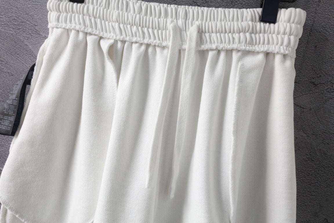 White shorts with elastic waistband and overlapping front pleats