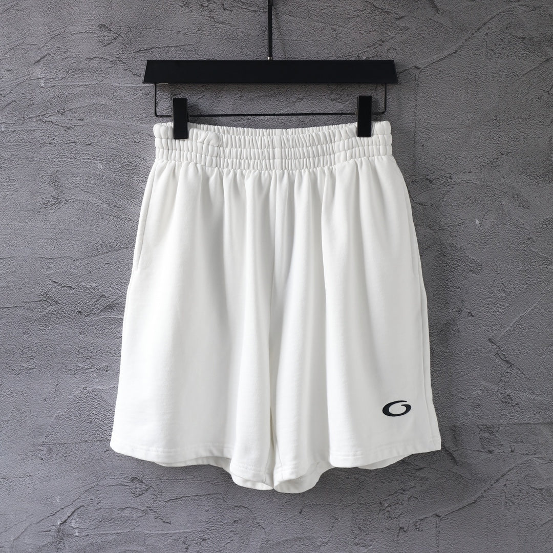 White Balenciaga shorts with elastic waistband and small black logo on leg
