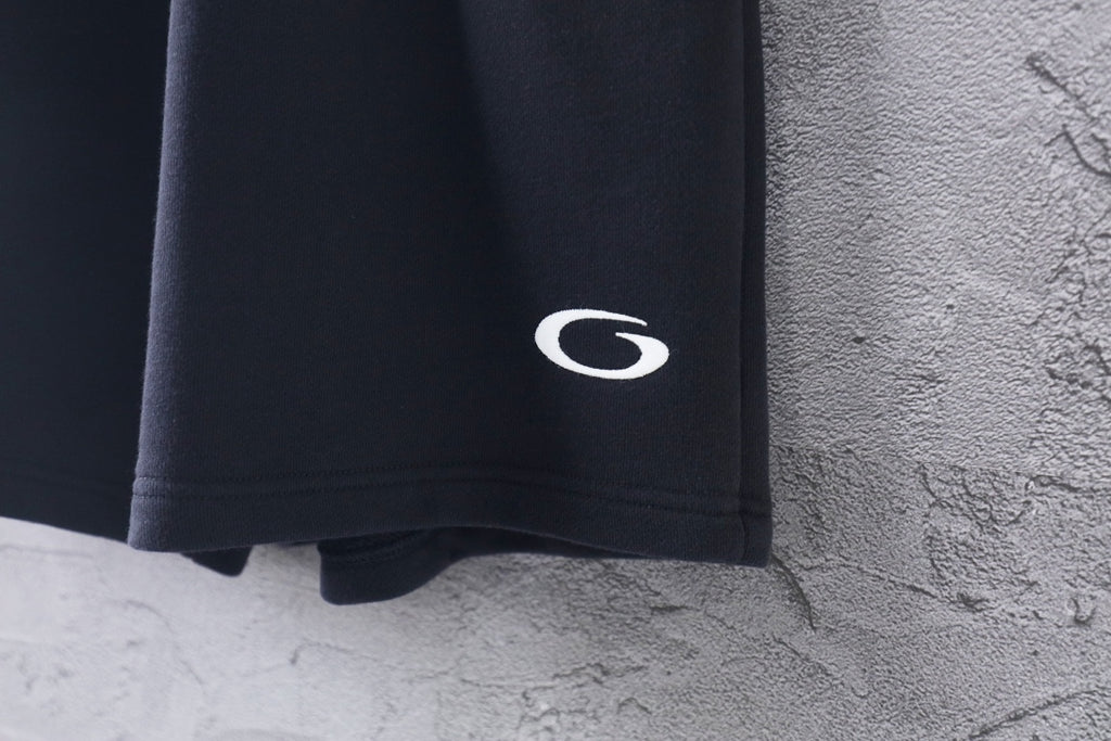Dark short-length Balenciaga pants with C logo on side hem