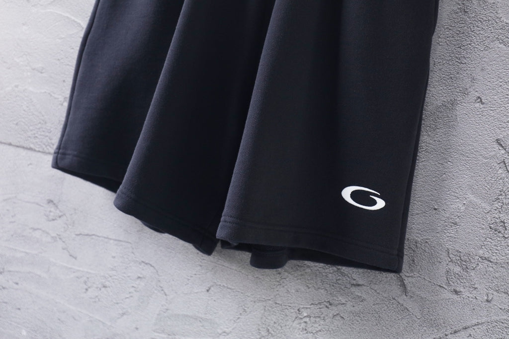 Dark short-length Balenciaga pants with side hem logo detail