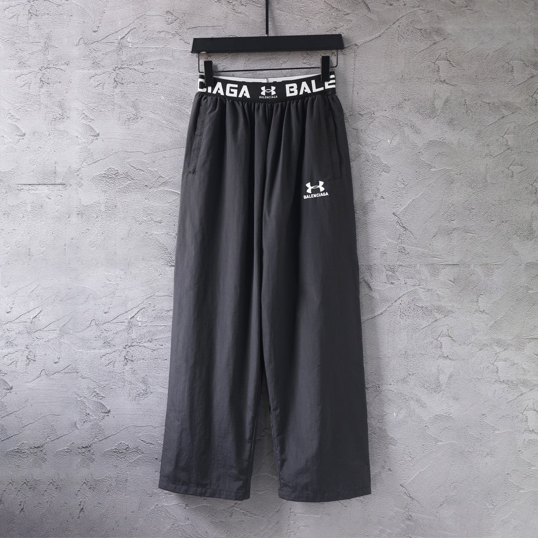 Black wide-leg pants with elastic waistband and Balenciaga logo print