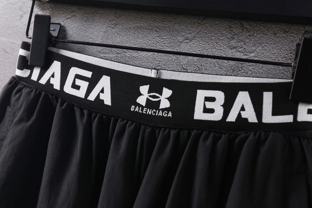Black waistband with bold Balenciaga branding and Under Armour logo