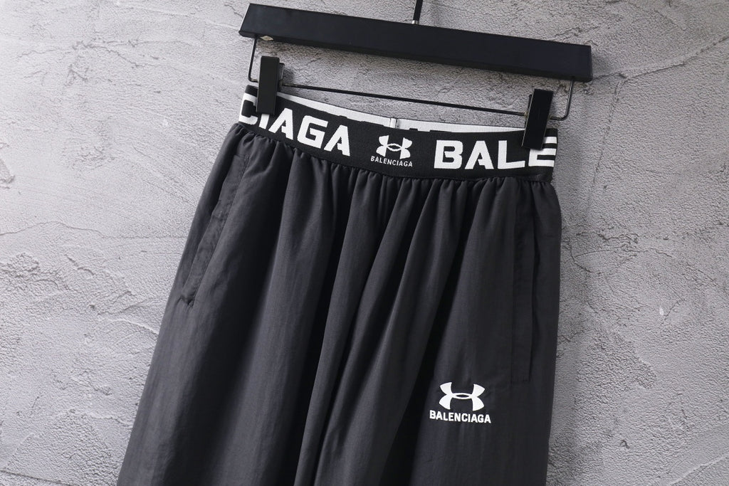 Black wide-leg pants with elastic waistband and Under Armour Balenciaga emblem