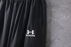 Black pants with printed Balenciaga logo near the front hemline