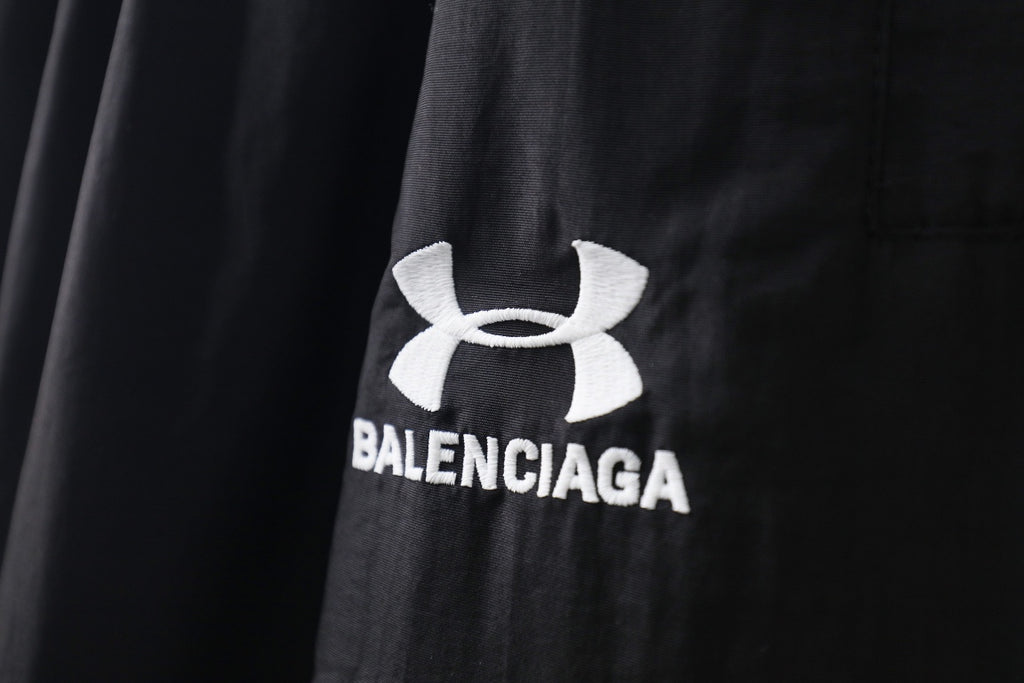 Black pants with Under Armour emblem and Balenciaga logo print