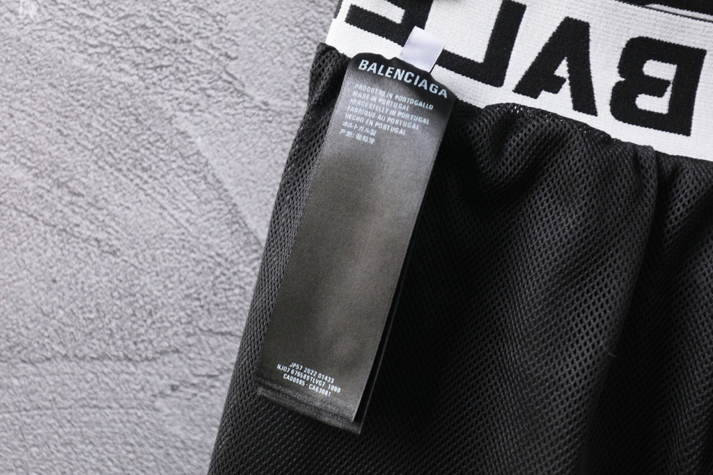 Black pants with inner care label and mesh-lined waistband area