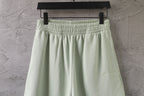 Light-green shorts with smocked elastic waistband and front pleats