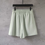 Light-green Balenciaga shorts with elastic waistband and pleated front