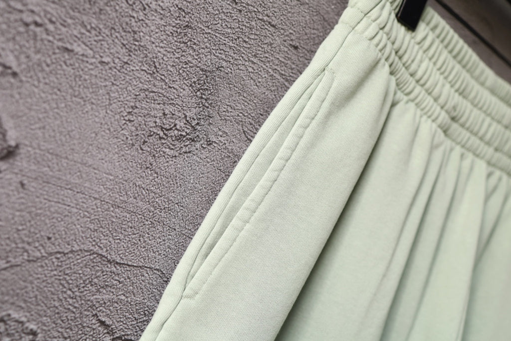 Balenciaga light green shorts with side seam and fabric texture close-up