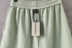 Balenciaga light green shorts with smocked waistband and attached brand tag
