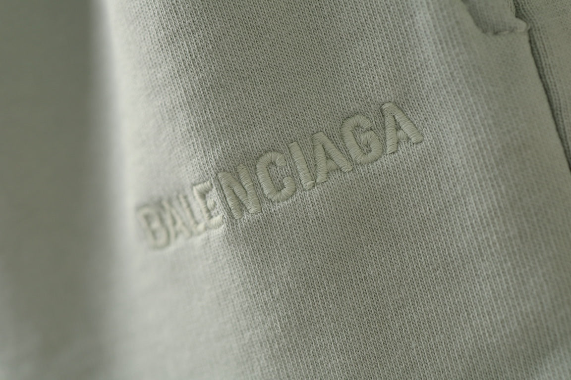 Balenciaga light green shorts with embroidered logo on fabric close-up