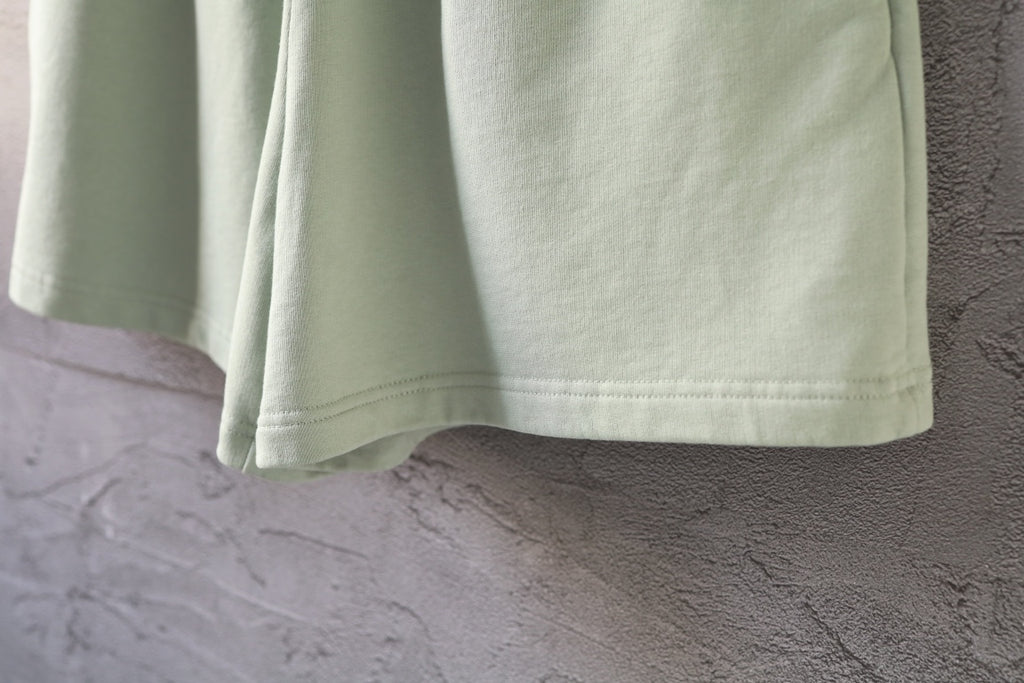 Light-green shorts hem with clean cuff and straight side seam
