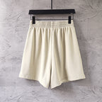 Cream shorts with elastic waistband and neat side seams, front view