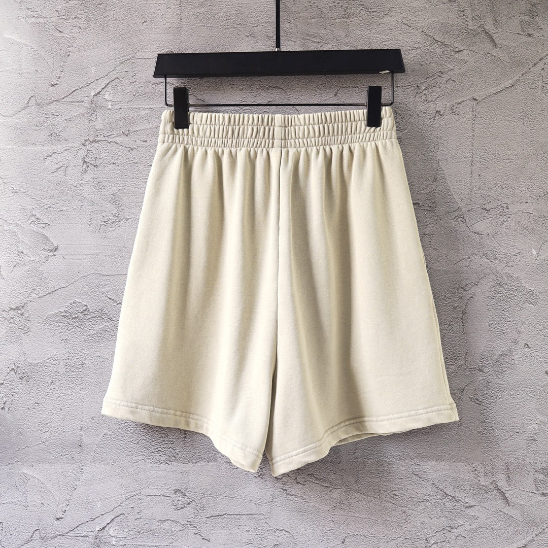 Cream shorts with elastic waistband and neat side seams, front view