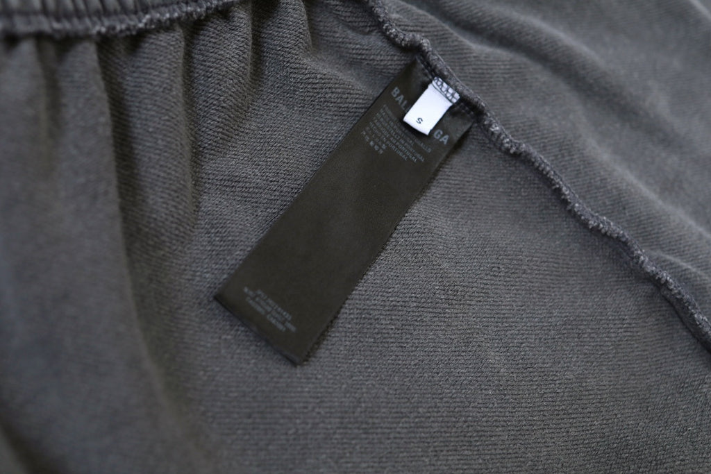 Inside waistband with black label on light gray shorts