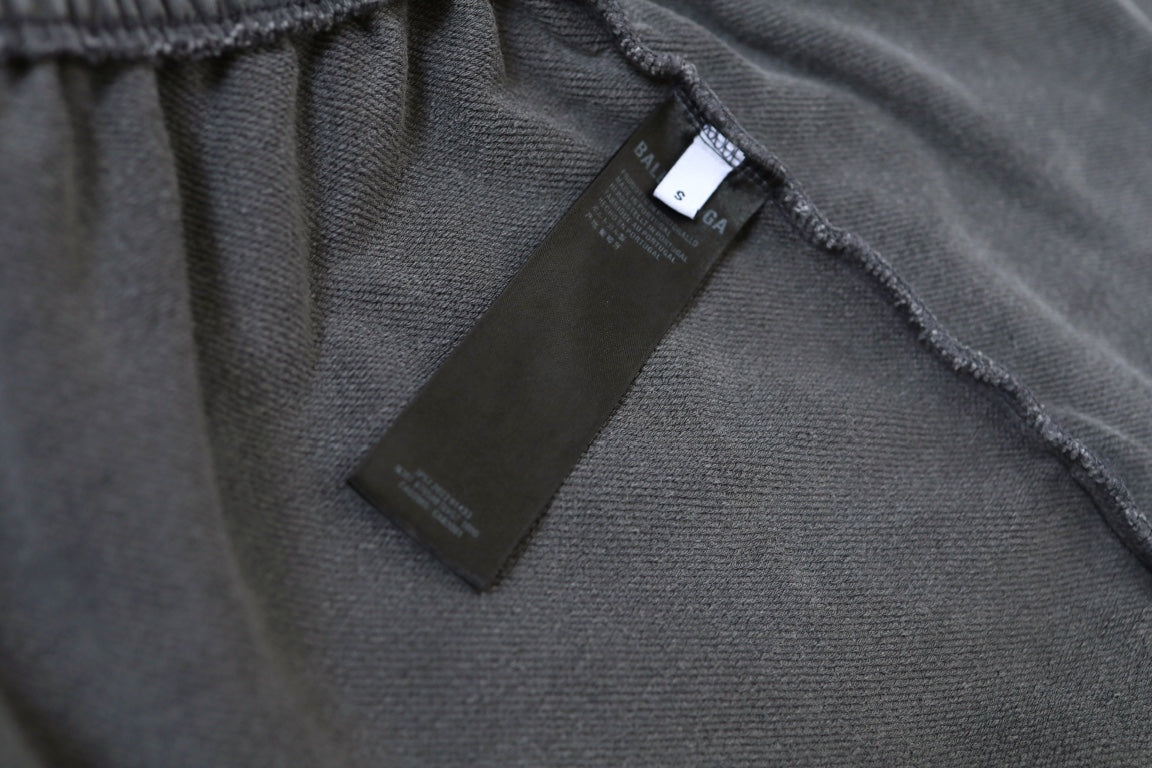 Inside waistband with black label on light gray shorts