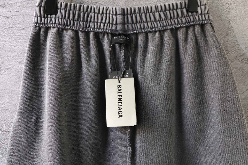 Light gray shorts with elastic waistband and hanging brand tag