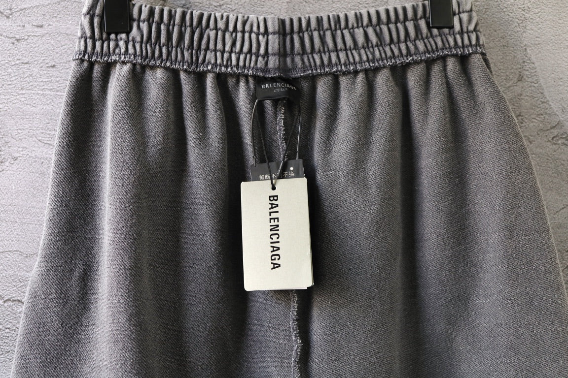 Light gray shorts with elastic waistband and hanging brand tag