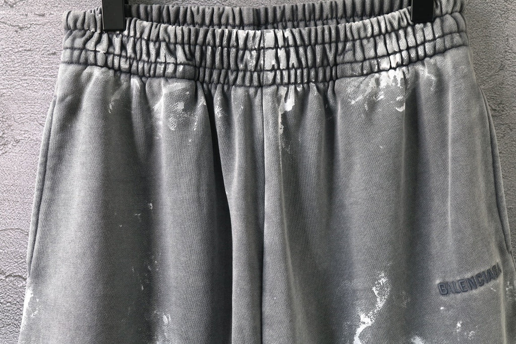 Elastic waistband and pleated front on light gray drawstring shorts