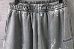 Elastic waistband and pleated front on light gray drawstring shorts
