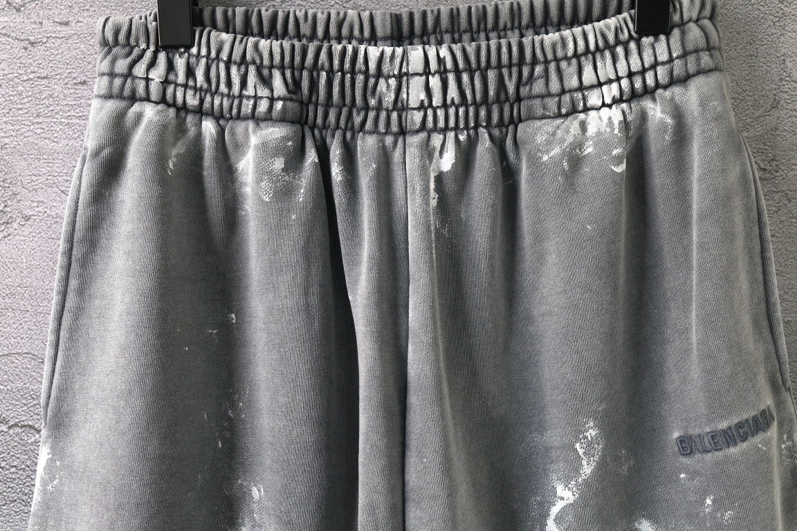 Elastic waistband and pleated front on light gray drawstring shorts