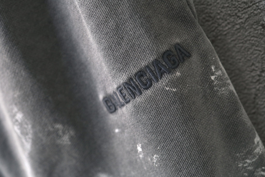 Light gray shorts with Balenciaga logo on leg, close-up