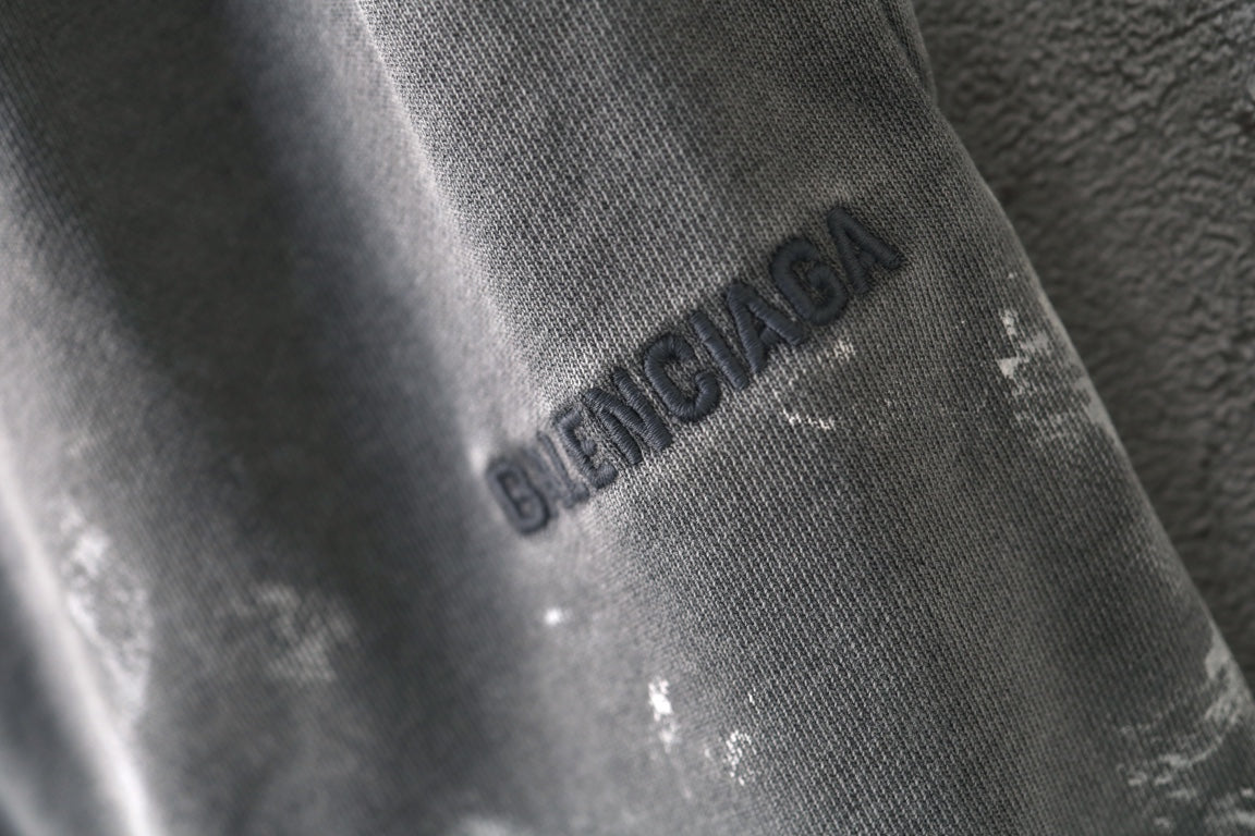 Light gray shorts with Balenciaga logo on leg, close-up