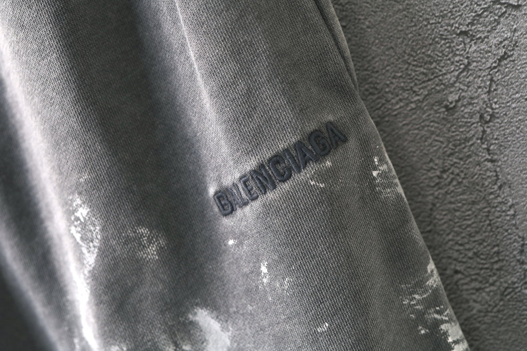 Light gray shorts with Balenciaga logo print on the leg