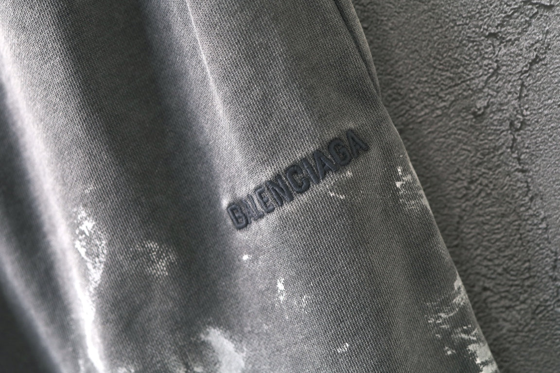 Light gray shorts with Balenciaga logo print on the leg
