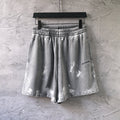 Drawstring shorts with elastic waistband, light gray with distressed print