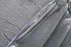 Side seam and tapered fold on light gray shorts