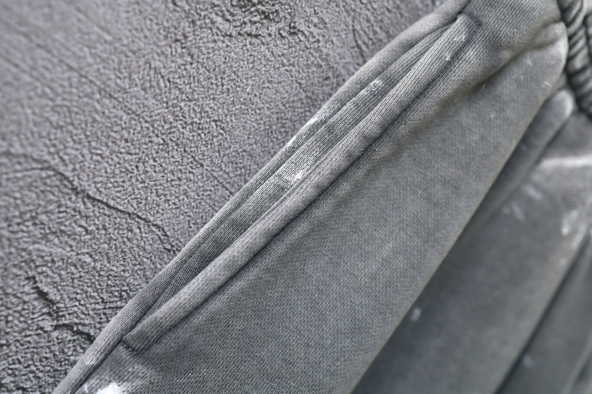 Side seam and tapered fold on light gray shorts