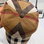 Burberry cap top view with round button and tan plaid panels