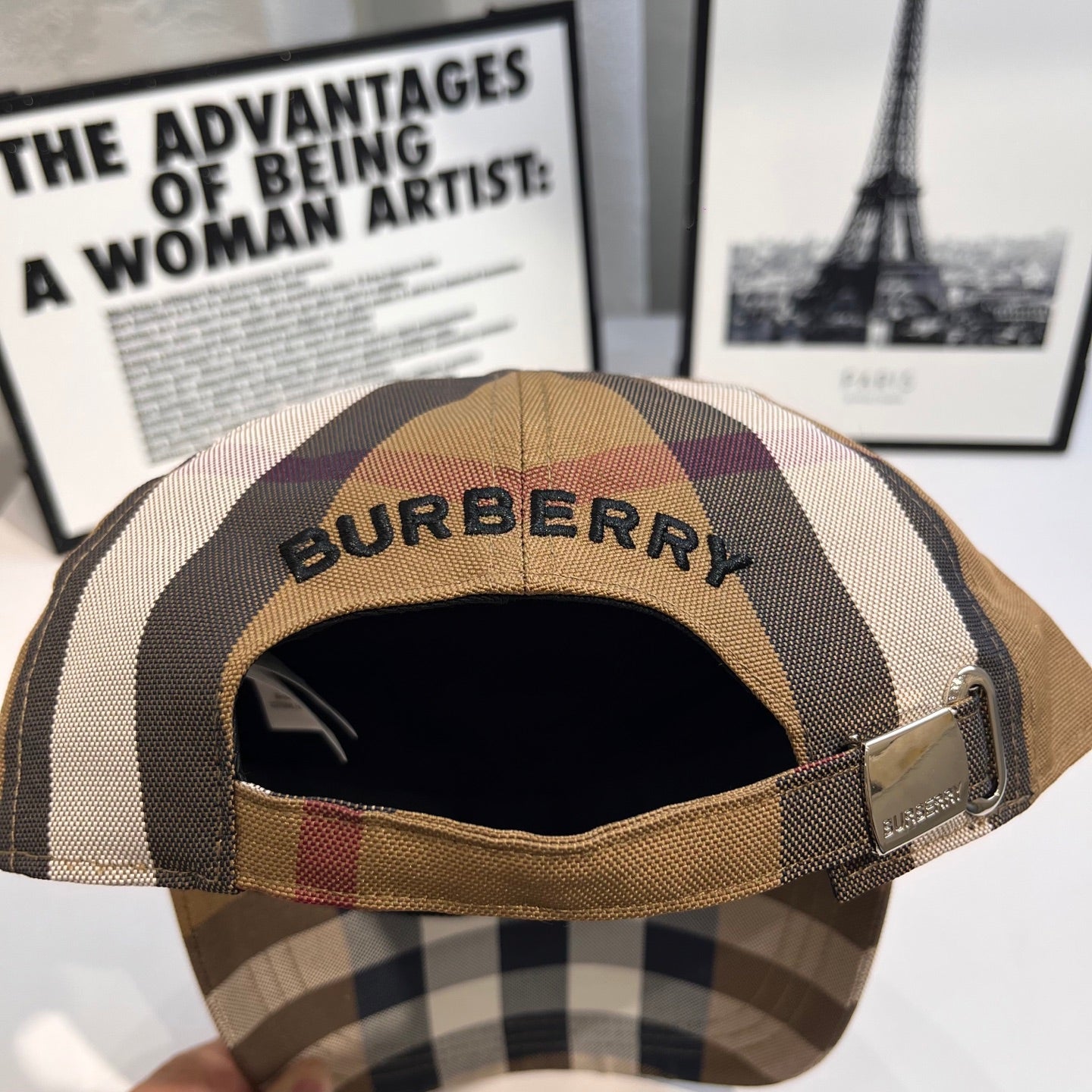 Burberry cap interior view with Burberry logo and adjustable strap buckle
