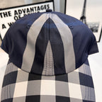 Back view of navy plaid baseball cap with gray and white vertical stripe panels
