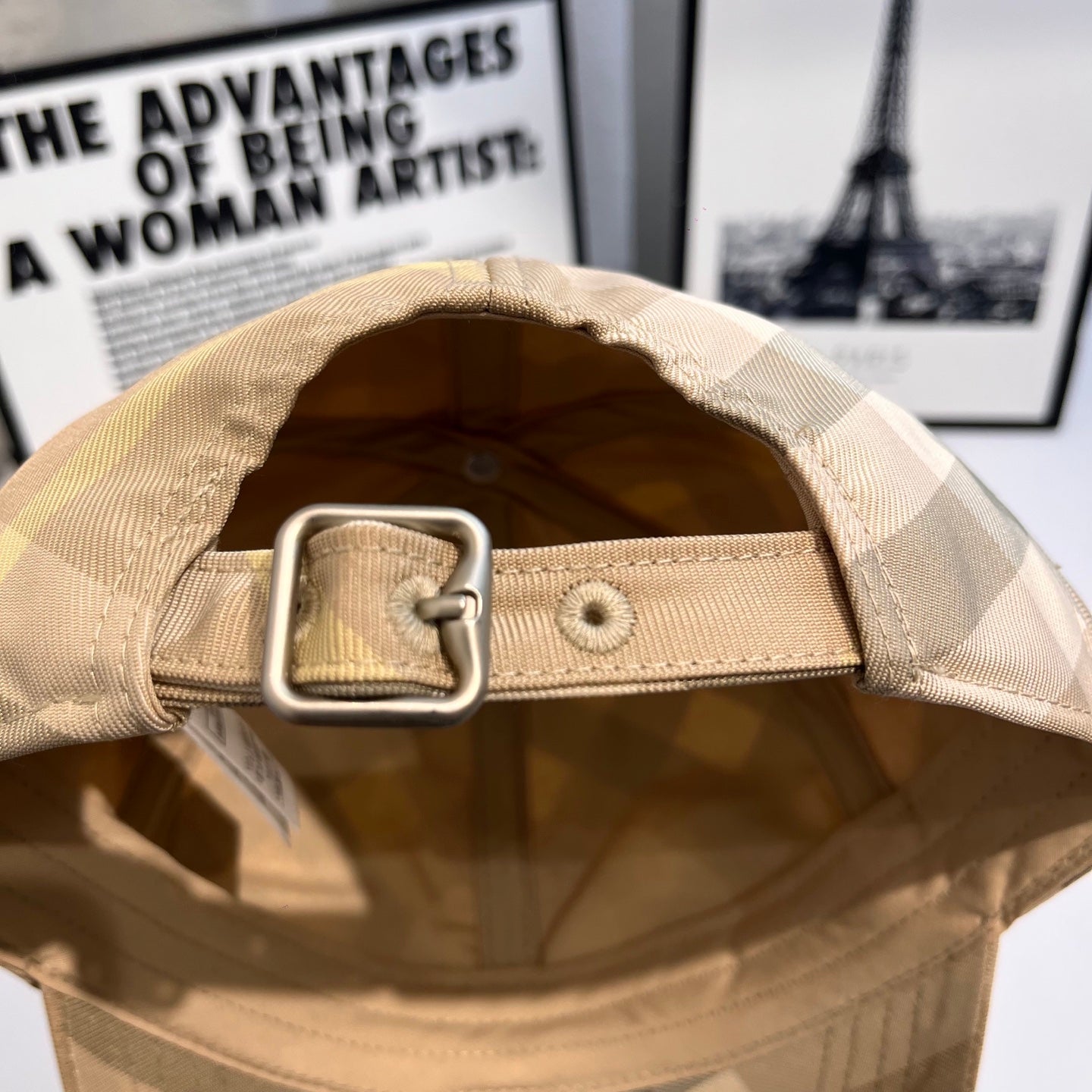 Beige plaid baseball cap interior with adjustable strap and metal buckle