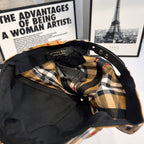 Plaid cap lining with Burberry logo label and adjustable black strap