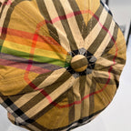 Burberry tartan plaid cap close-up of crown button with seam detail and colorful bands