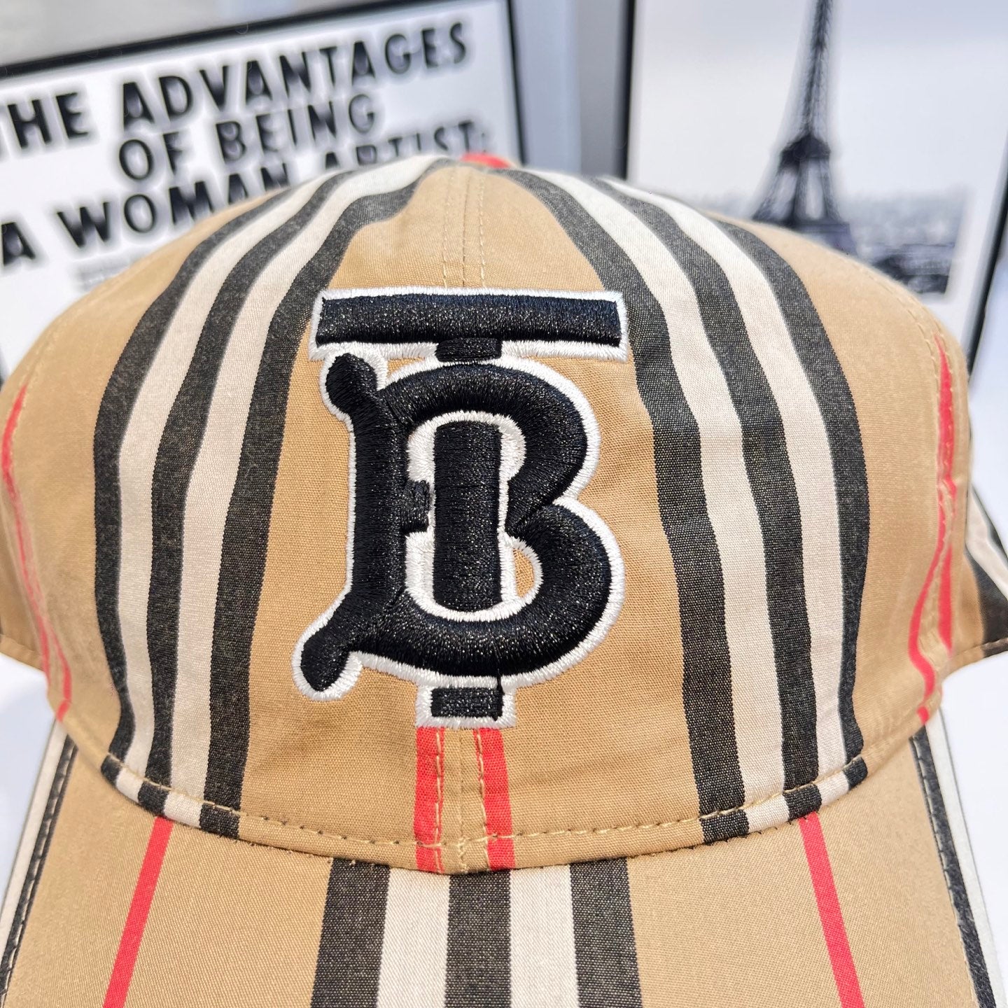Striped baseball cap close-up of navy B logo patch