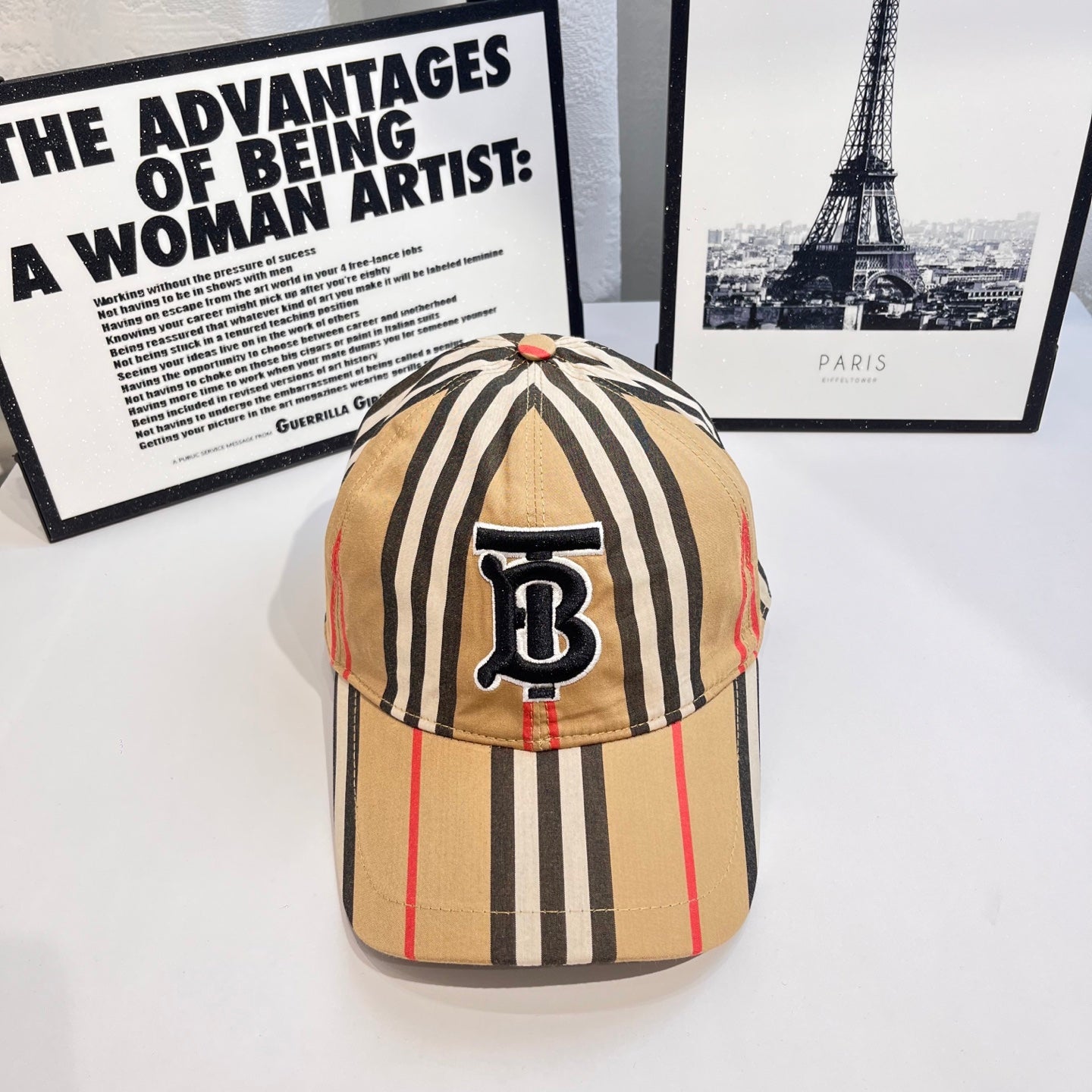 Striped baseball cap with navy B logo patch and curved brim