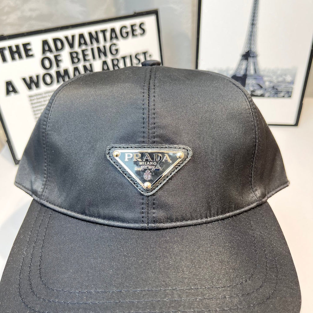Prada baseball cap in dark gray fabric with embroidered triangular logo patch on crown