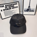 Prada baseball cap in dark fabric with front triangular logo patch and curved brim